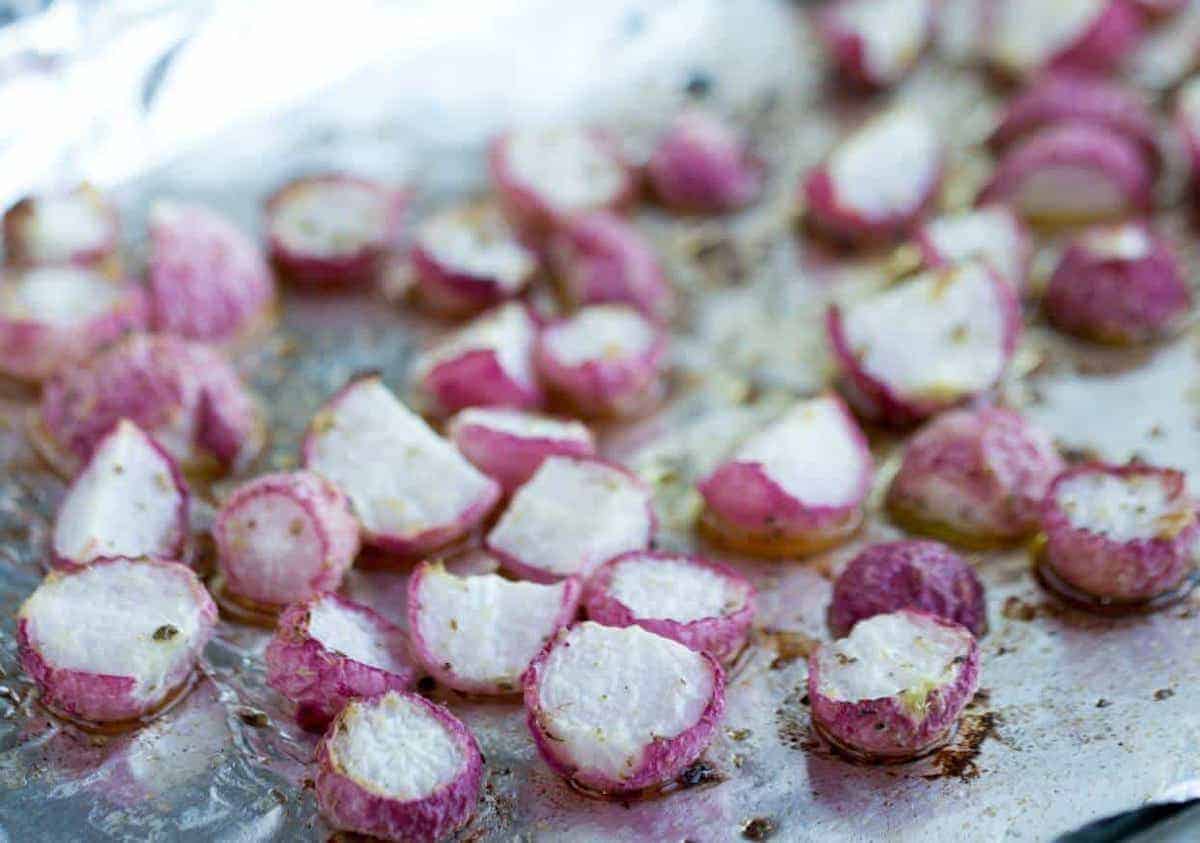 Roasted radishes on foil lined pan.