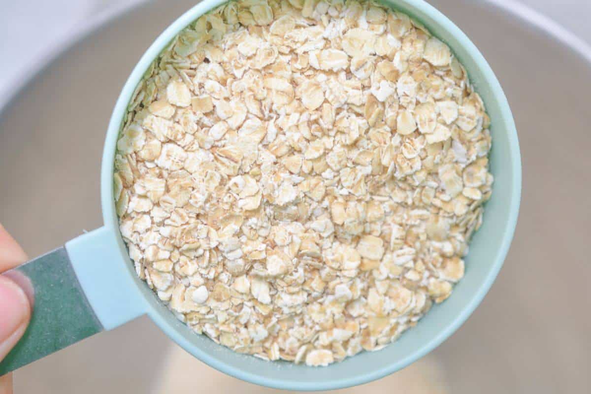 Adding oats to mixing bowl.
