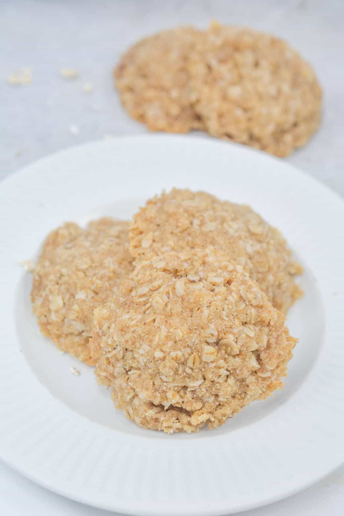 Vegan gluten-free oatmeal cookies on plate and table.