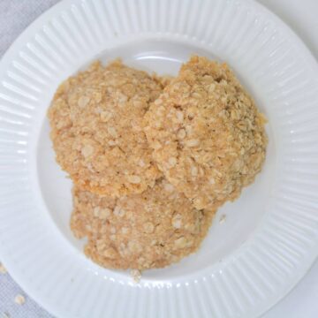 Vegan gluten-free oatmeal cookies on white plate.