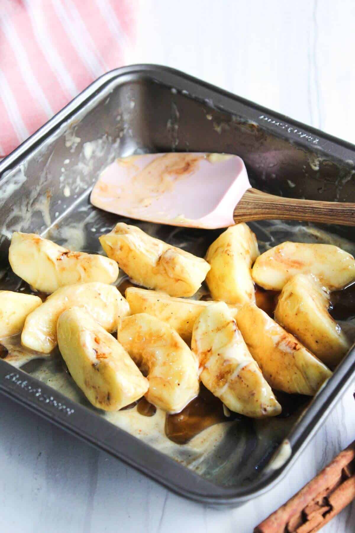 Cinnamon mixture and maple syrup mixture added to apple slices.