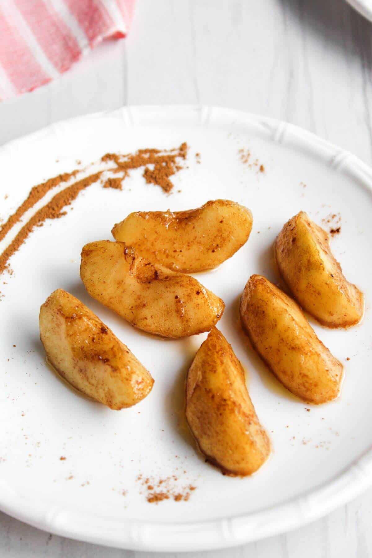 Overhead view of air fryer apples on plate.