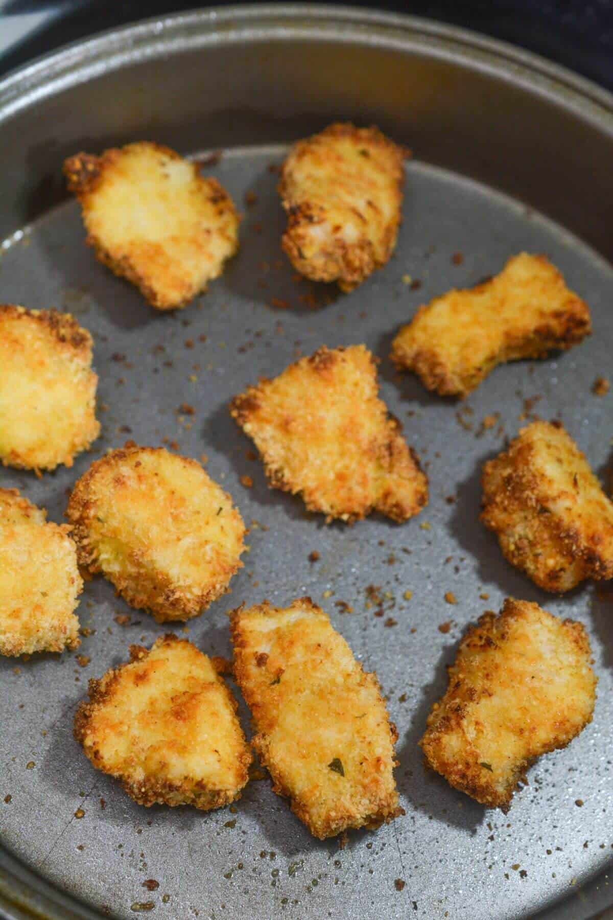 Air fried chicken nuggets in baking pan.