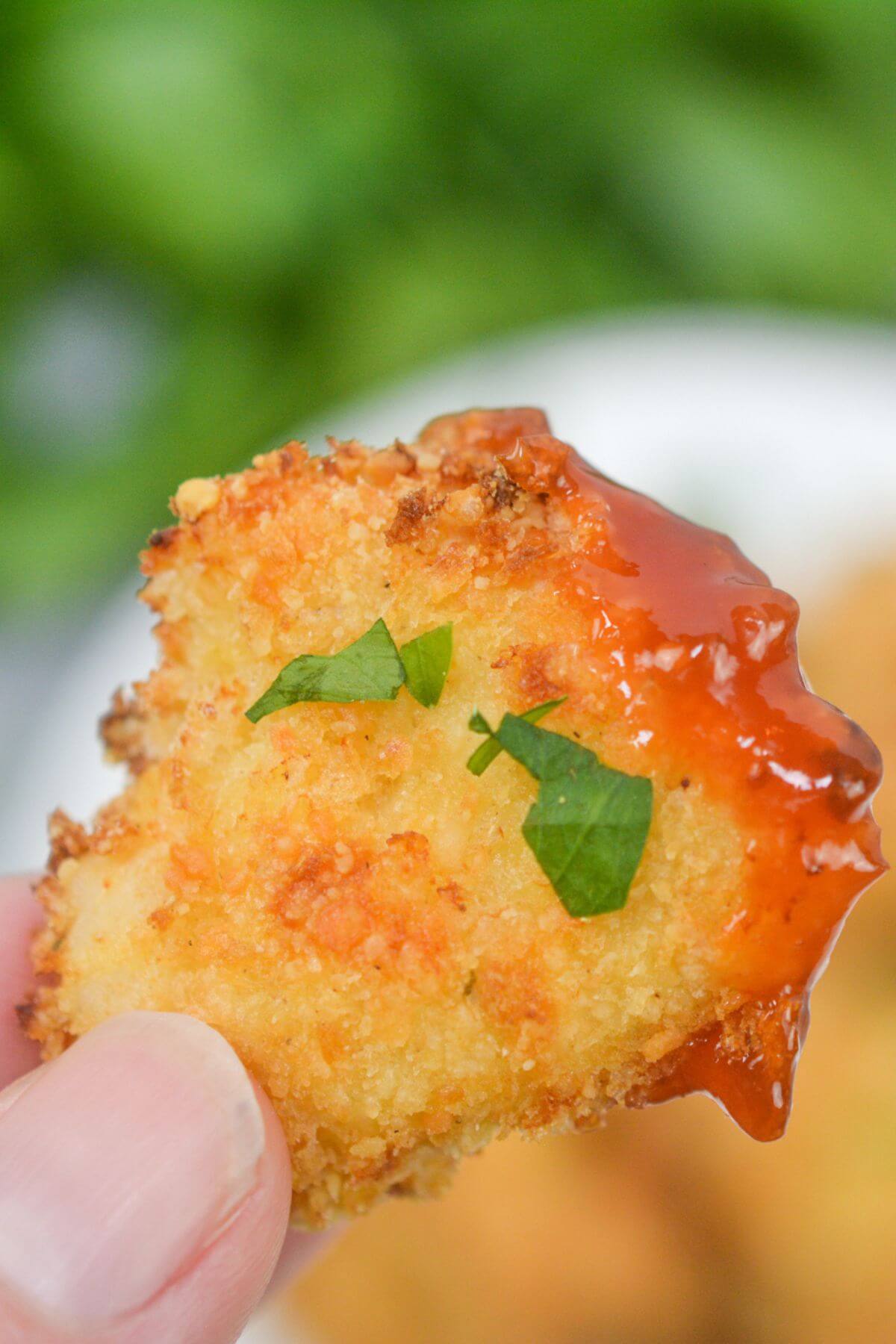Chicken nugget dipped in barbecue sauce.