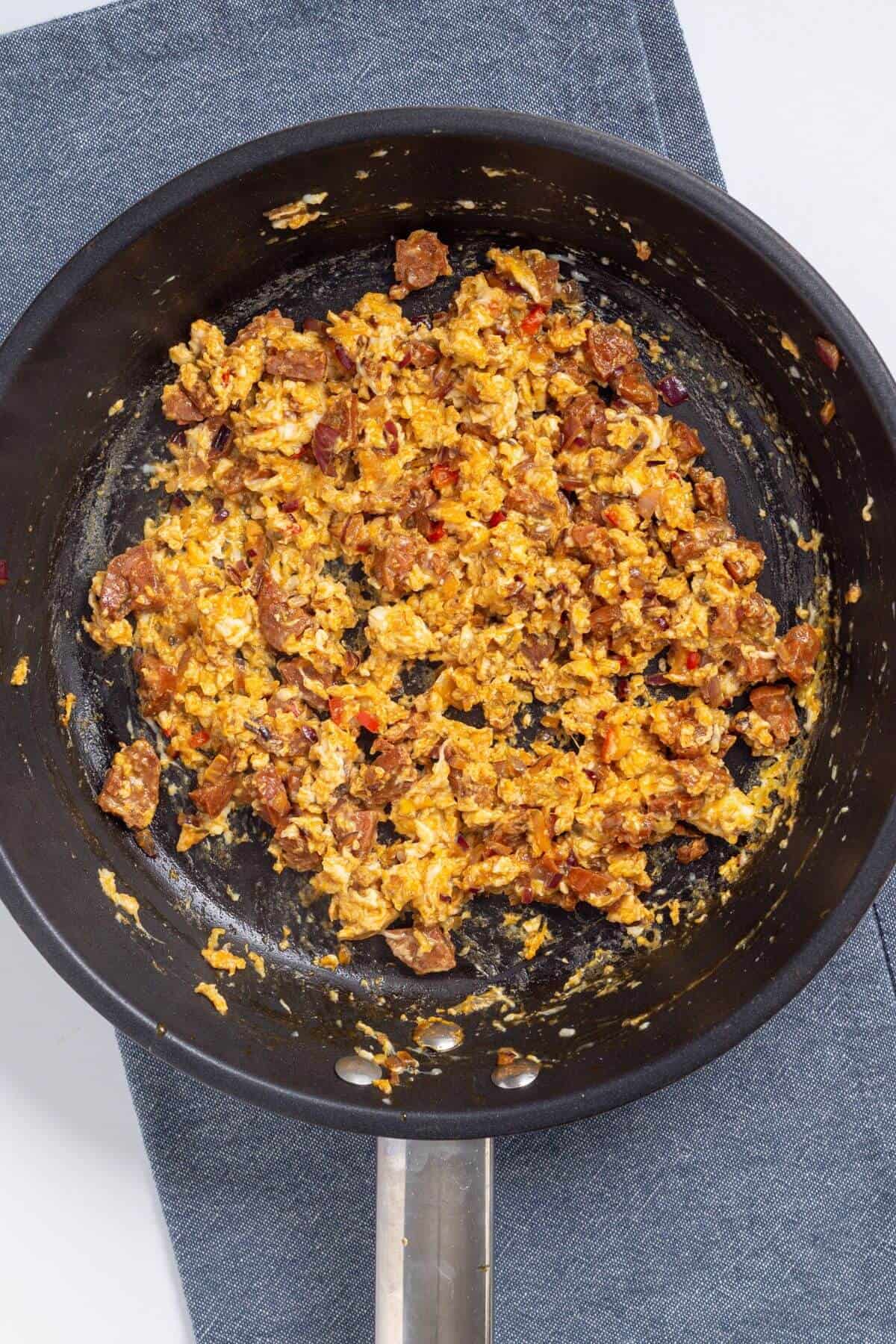 Cooked egg and chorizo mixture in skillet.