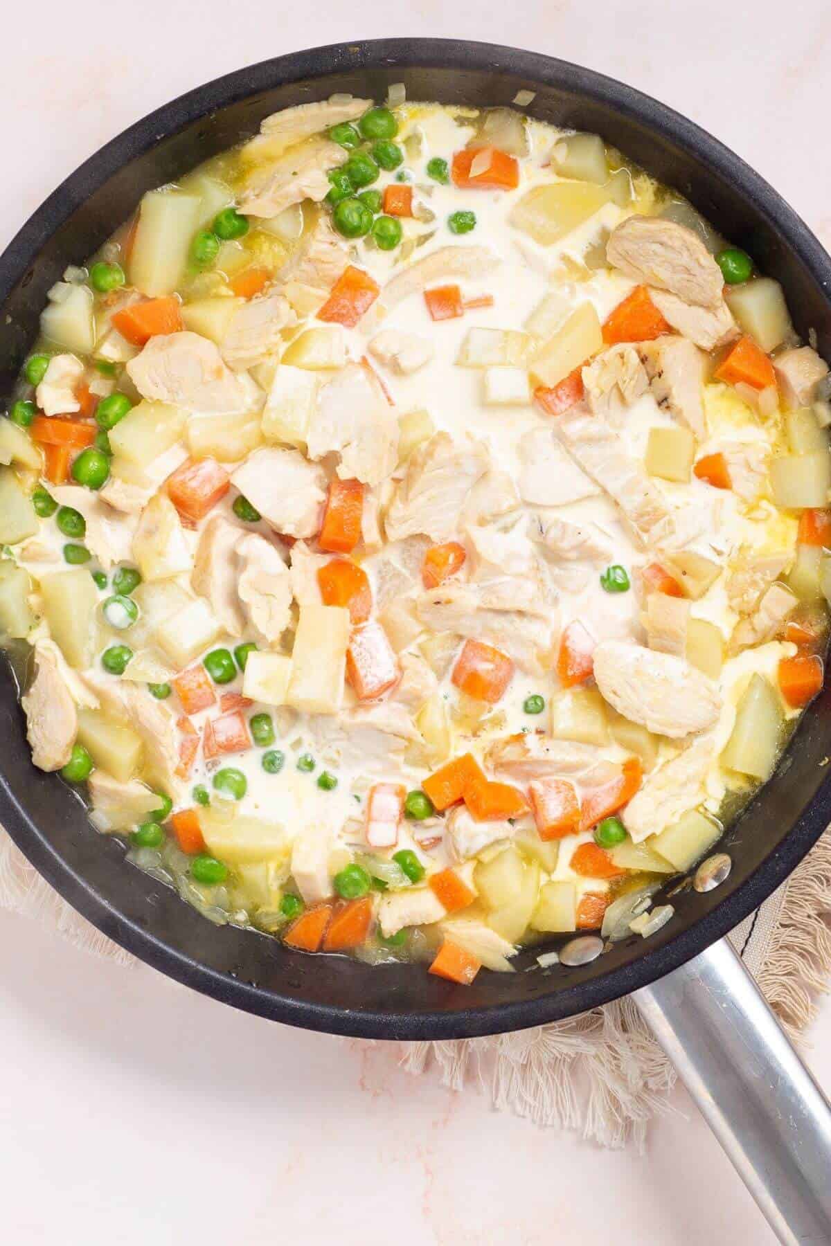 Broth and chicken added to skillet.