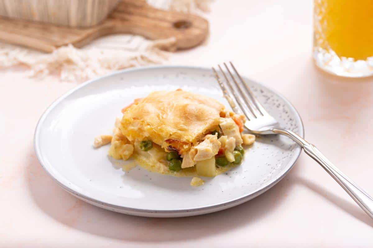 Square serving of chicken pot pie casserole on plate.