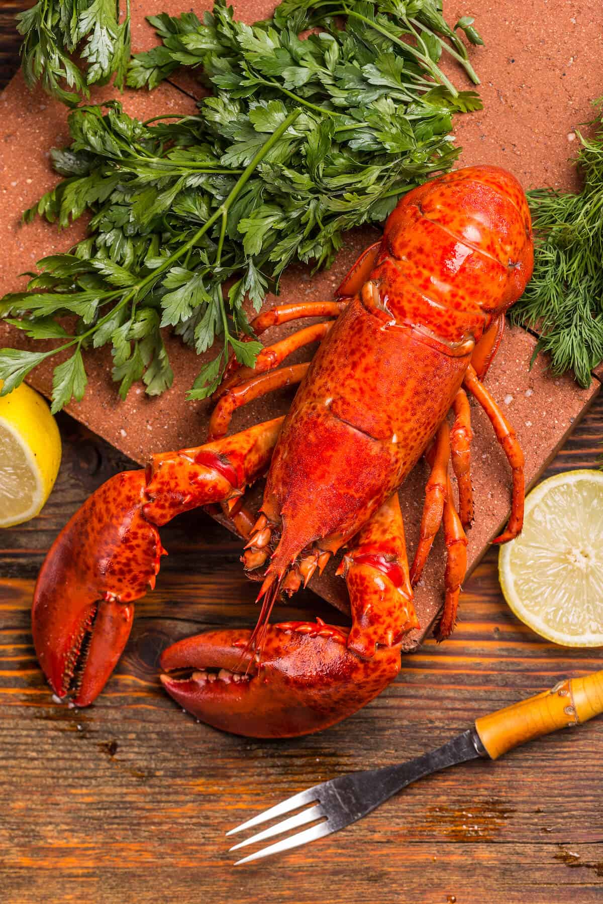 Top view of cooked lobster on wooden background.