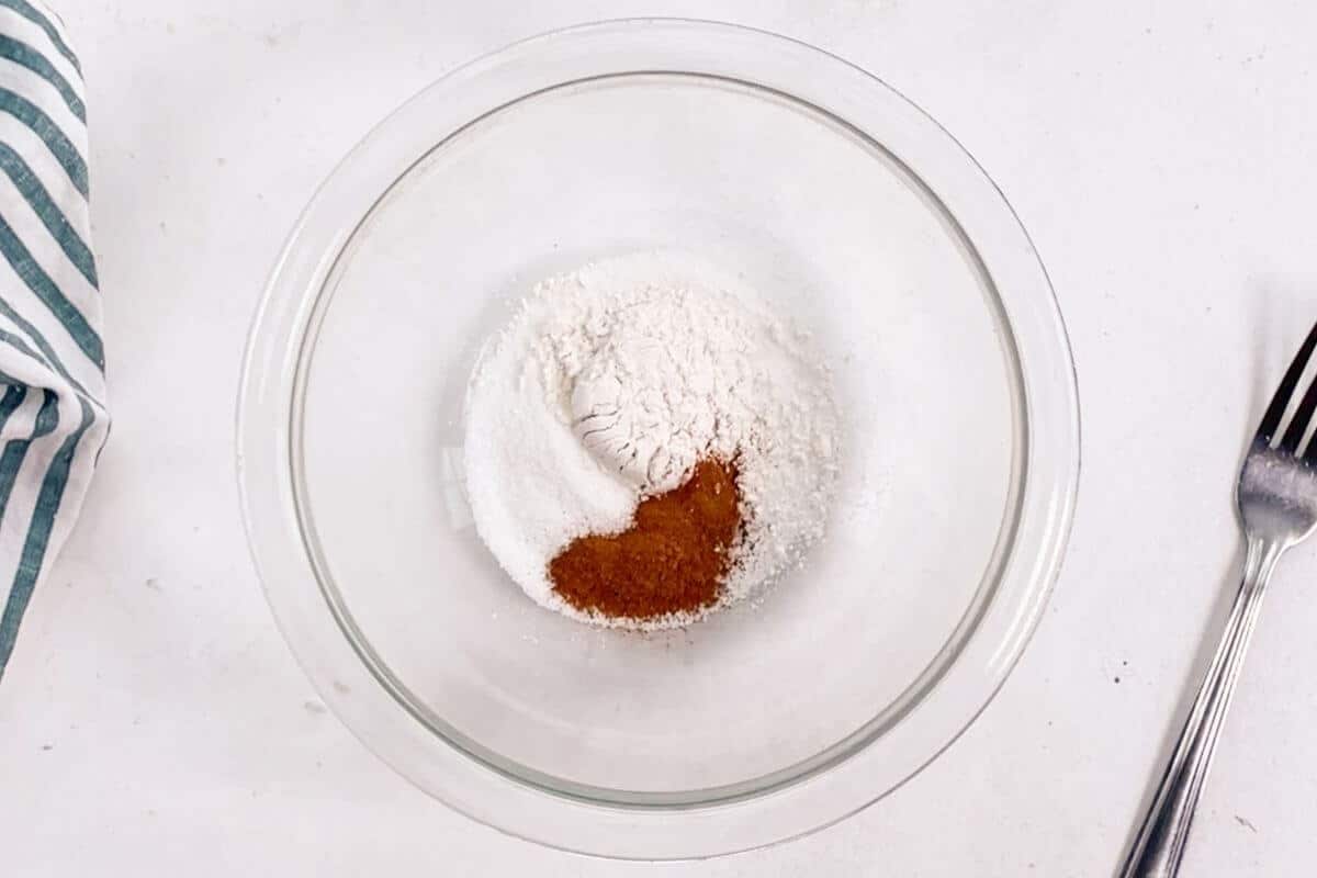 Flour sugar cinnamon in mixing bowl.