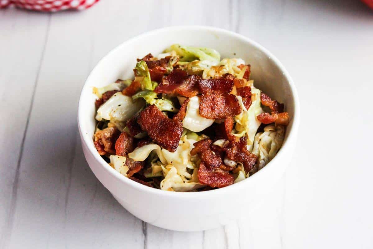 Cabbage and bacon in serving bowl.