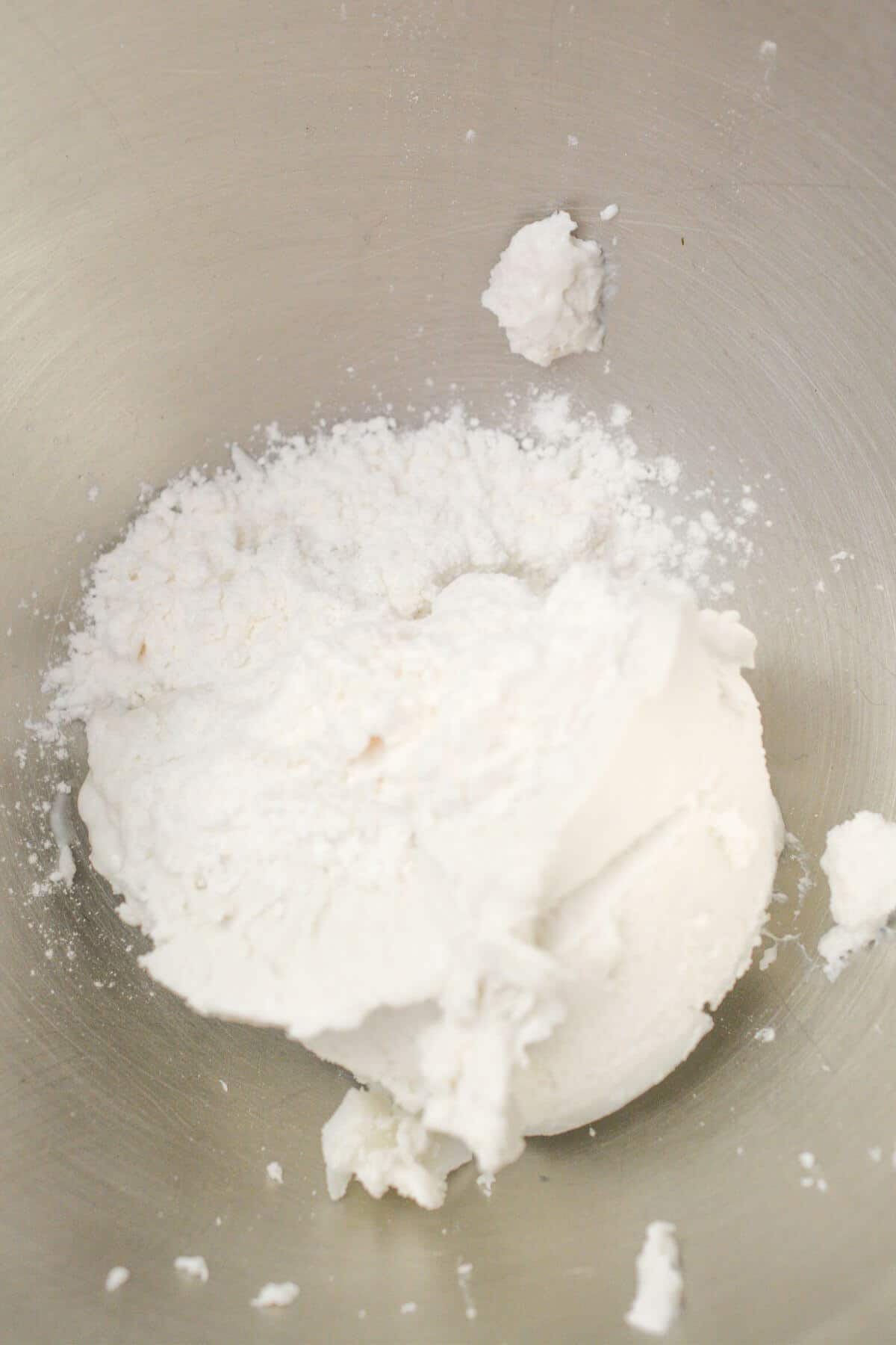 coconut cream and powdered sugar in mixing bowl.