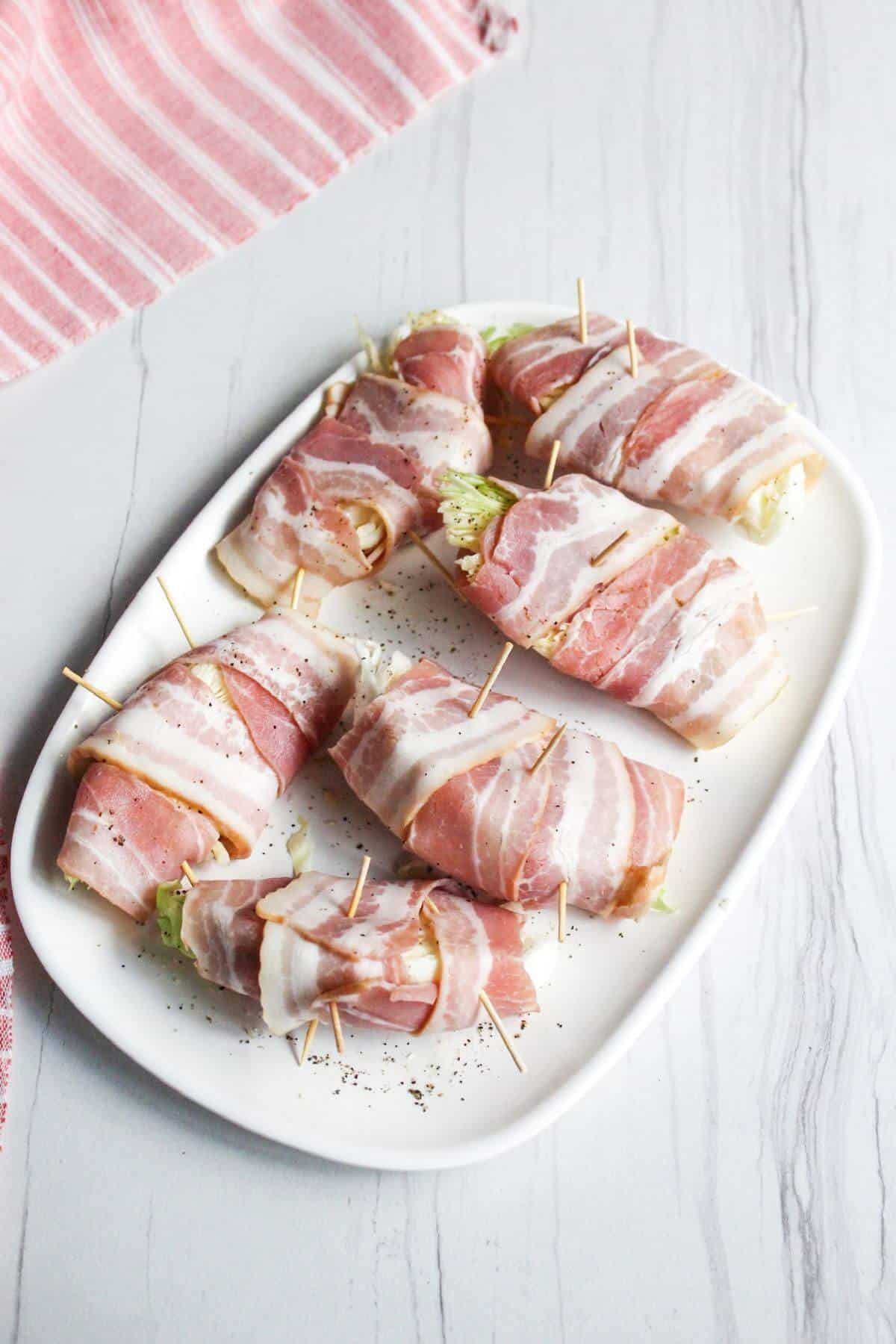 Seasoned cabbage wedges wrapped in bacon.