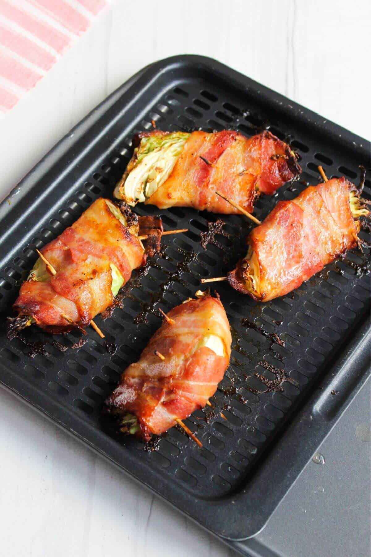 Air fried cabbage wedges wrapped in bacon.