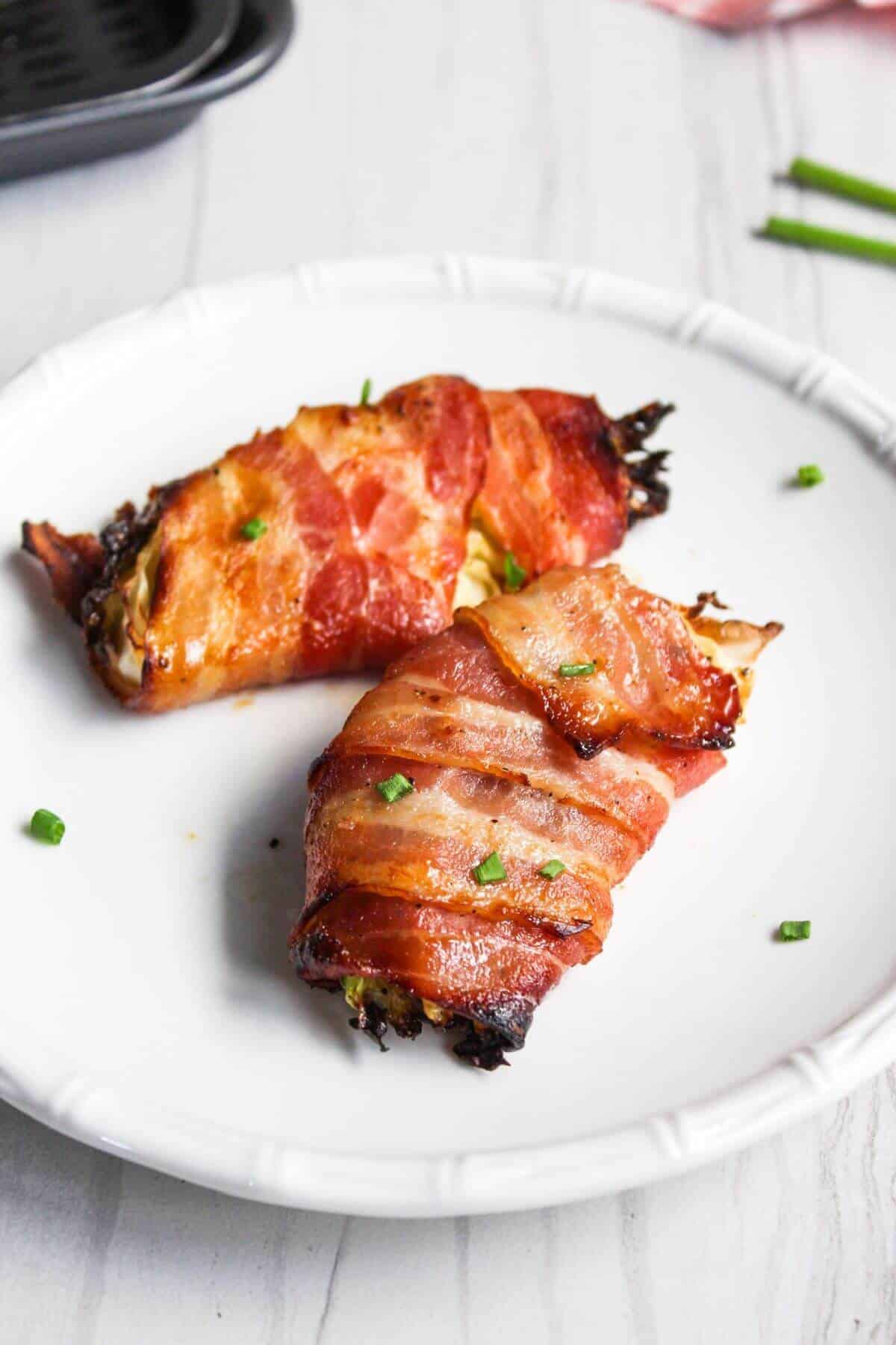 Bacon wrapped air fryer cabbage wedges on plate.