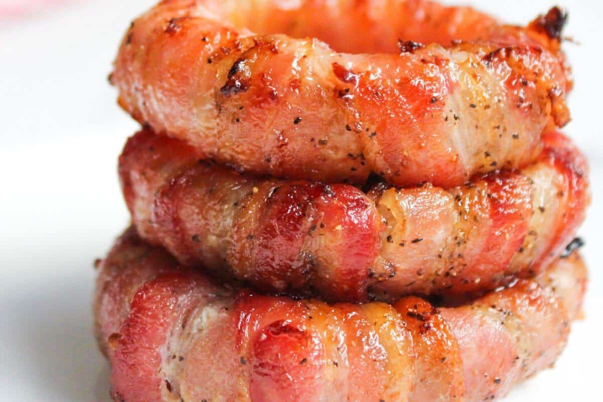 Stack of bacon wrapped onion rings.