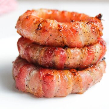 Stack of bacon wrapped onion rings.