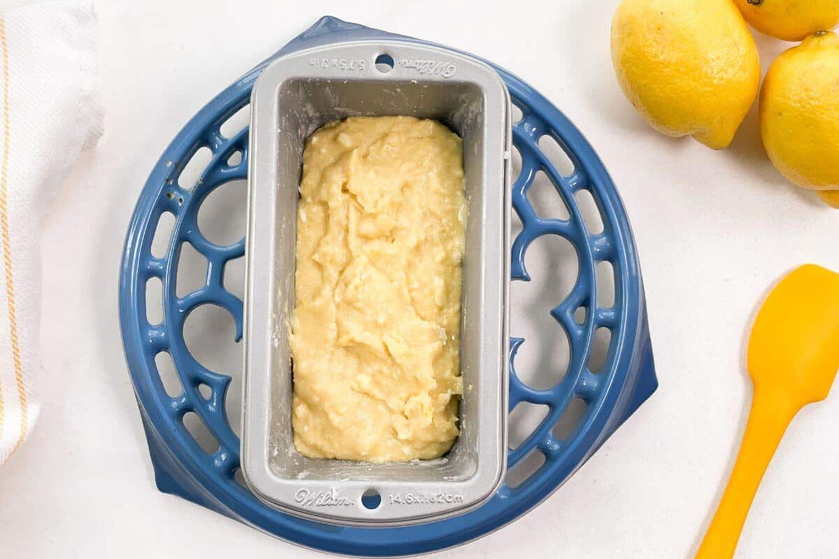 Lemon loaf batter in mini loaf pan.