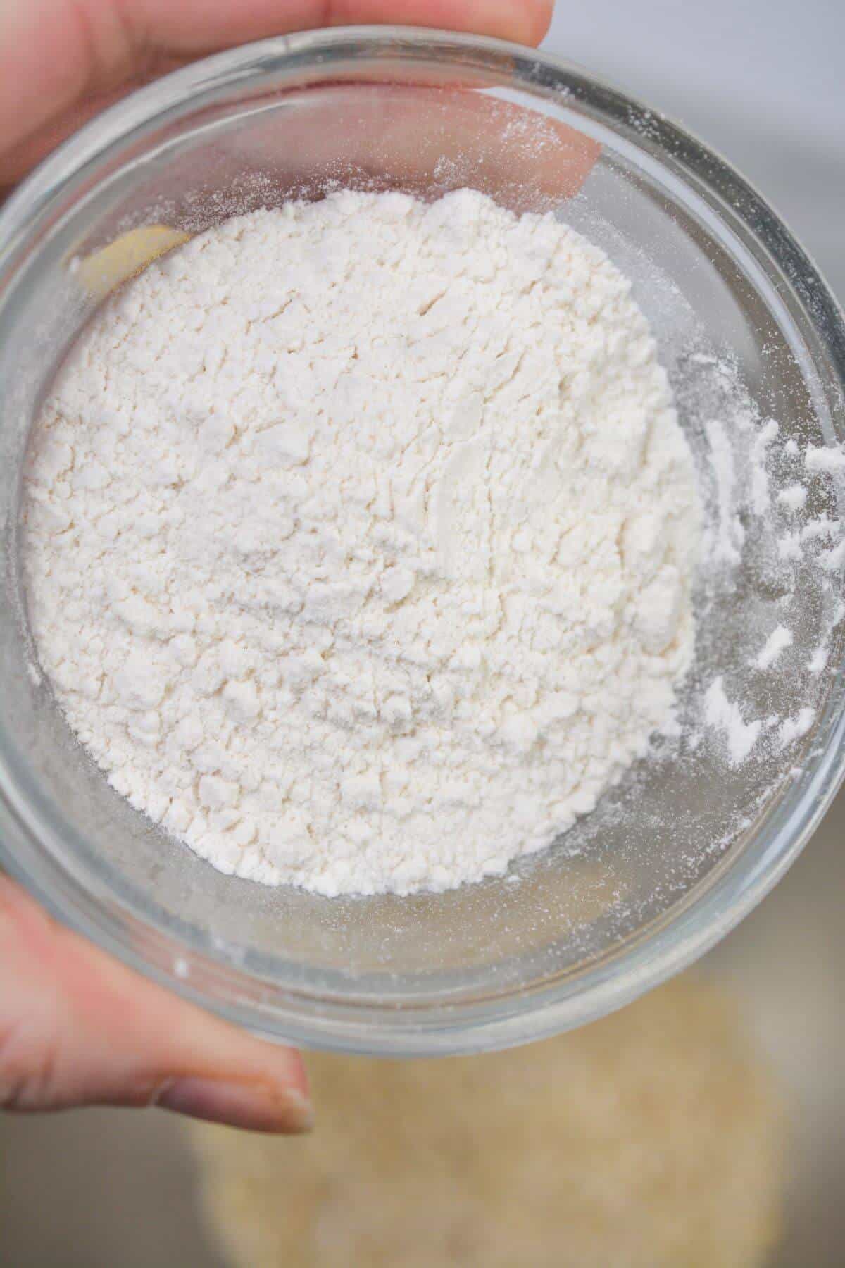 Adding flour to mixing bowl.