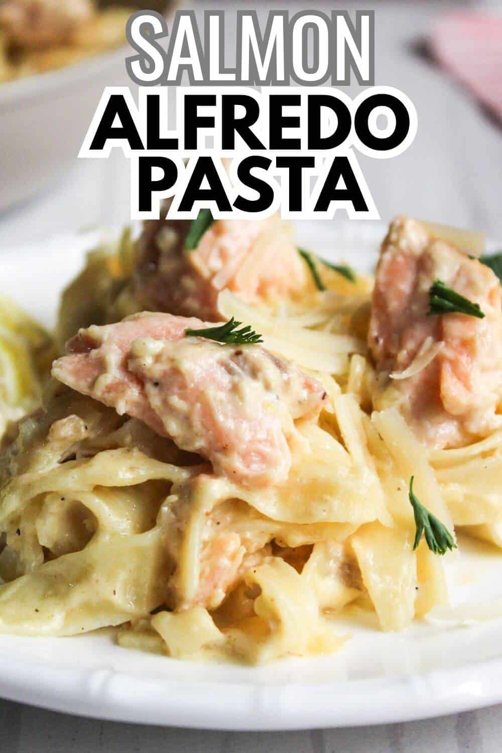 Salmon alfredo pasta with text overlay.