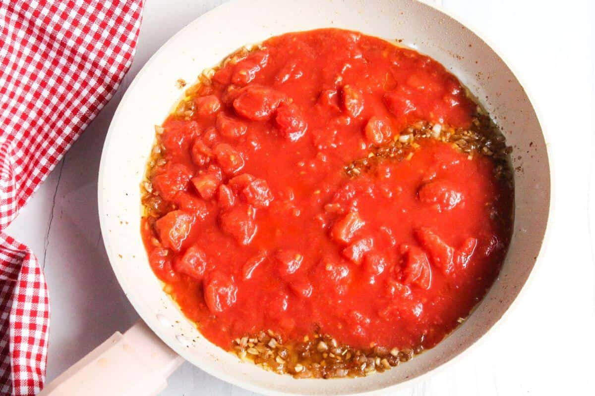 Tomato sauce added to skillet.