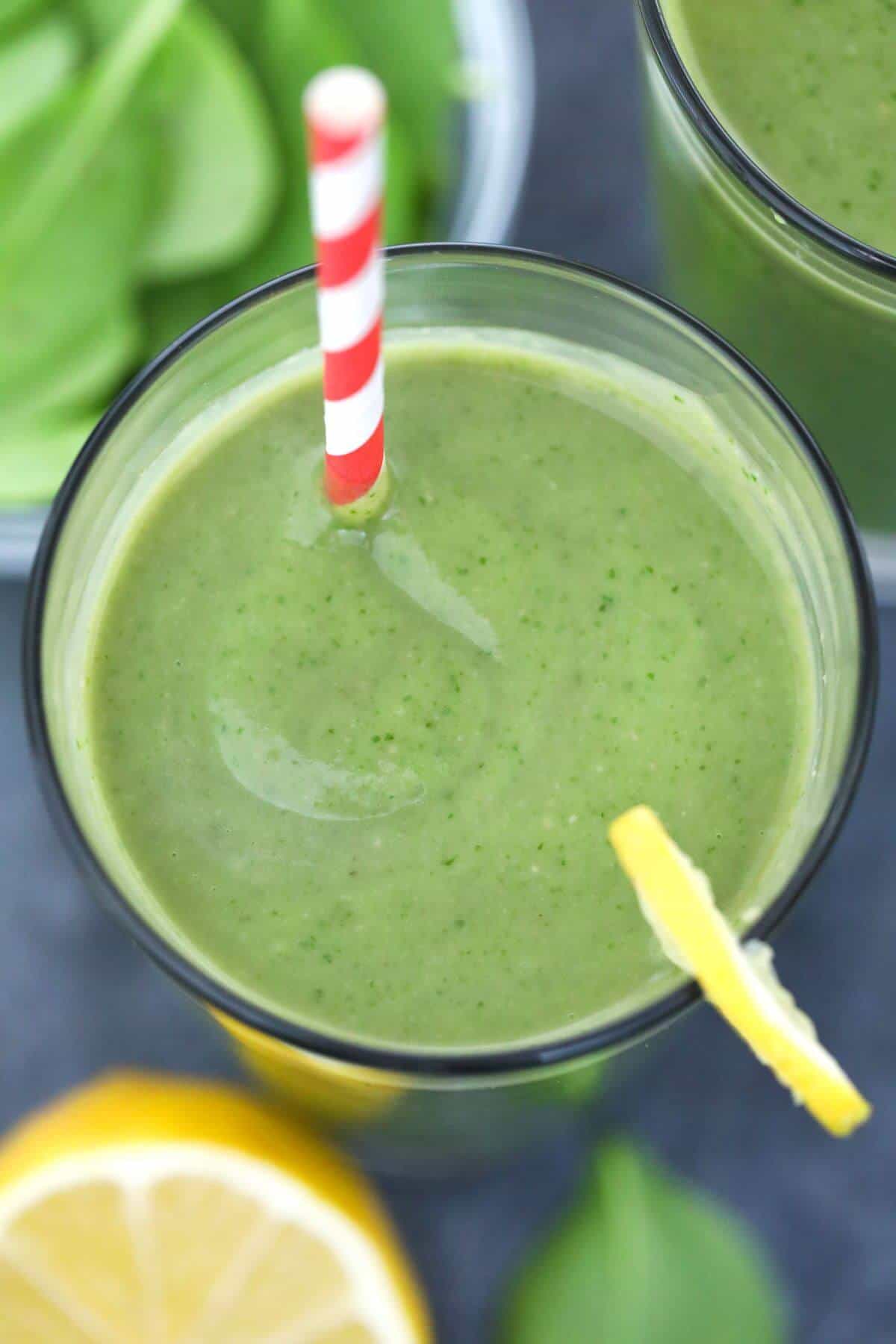 Overhead look into glass with avocado spinach smoothie.