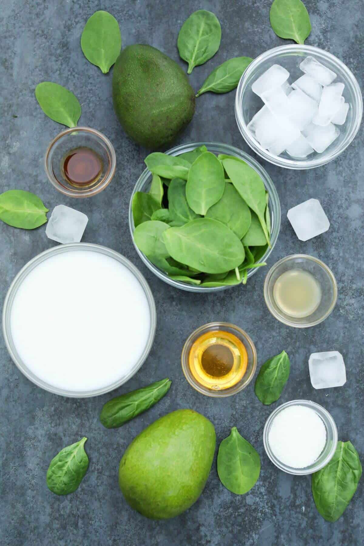 Ingredients for the green avocado spinach smoothie recipe.