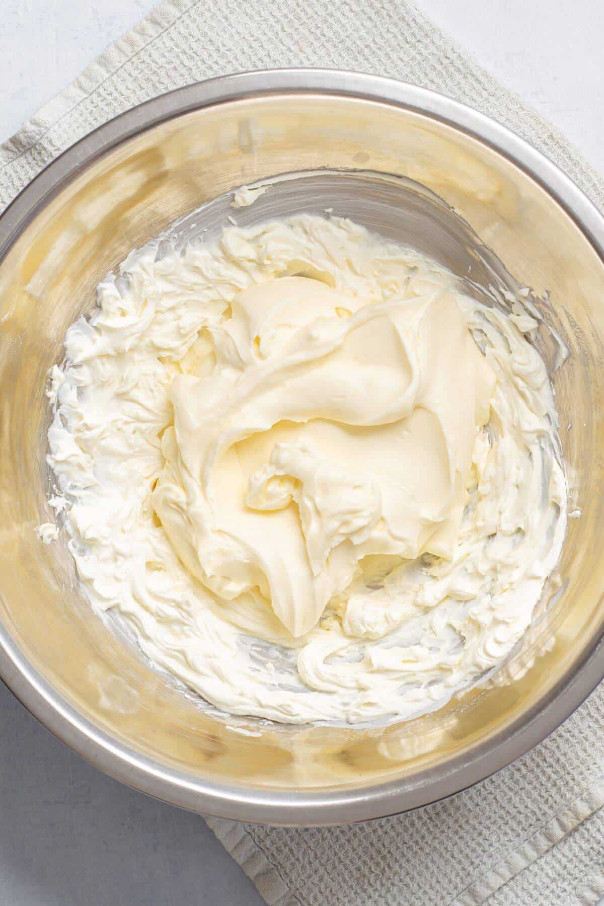 Whipped cream added to mixing bowl.