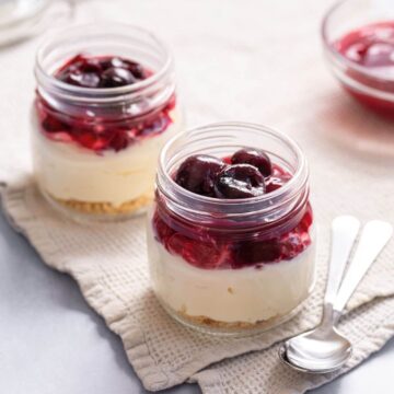 Cheesecake in jars with cherry filling.