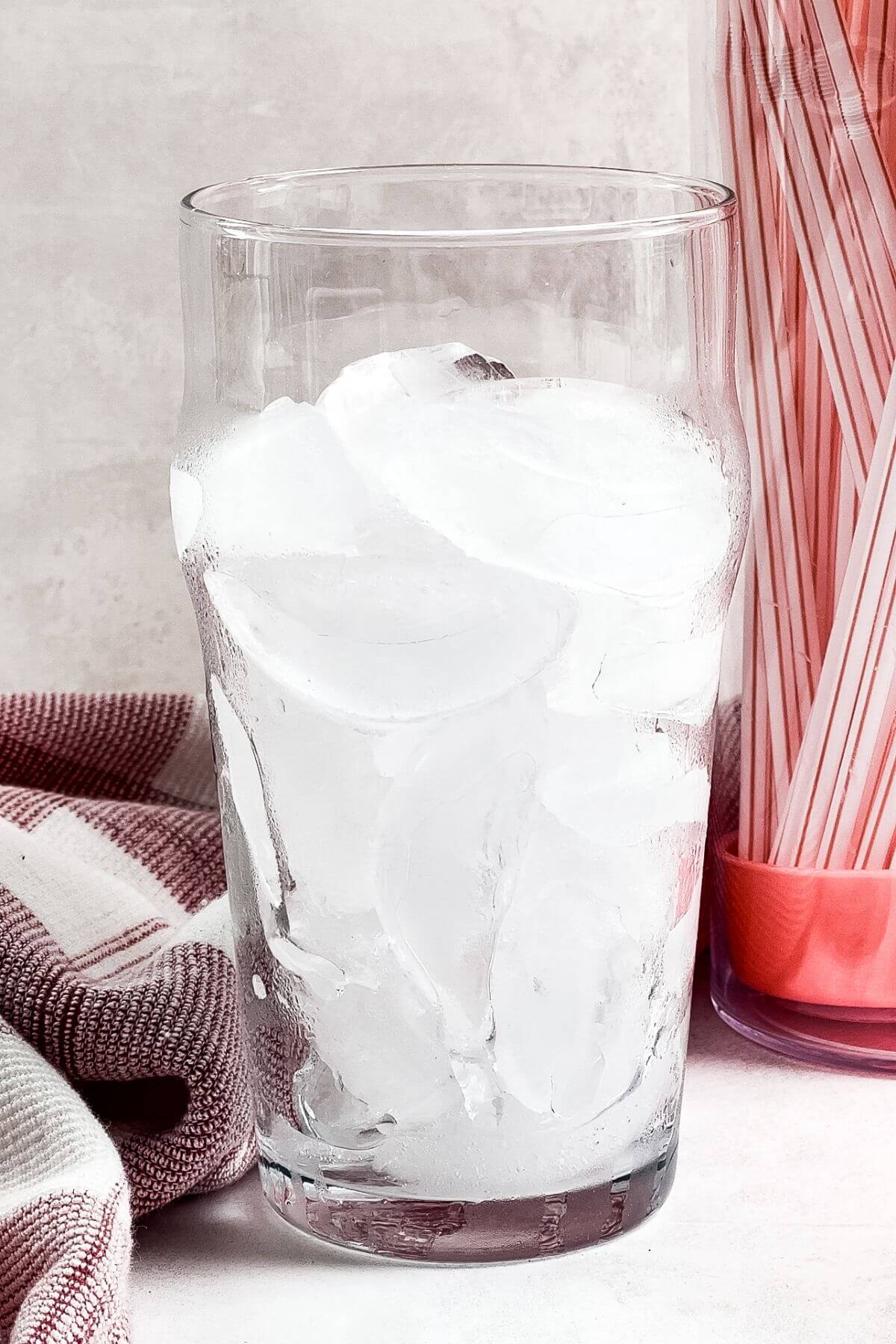 Tall glass filled with ice.