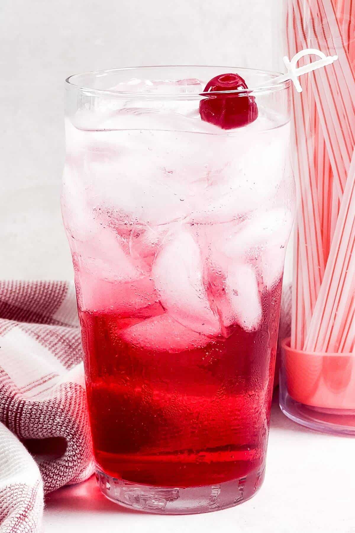 Maraschino cherry added to top of Shirley Temple drink.