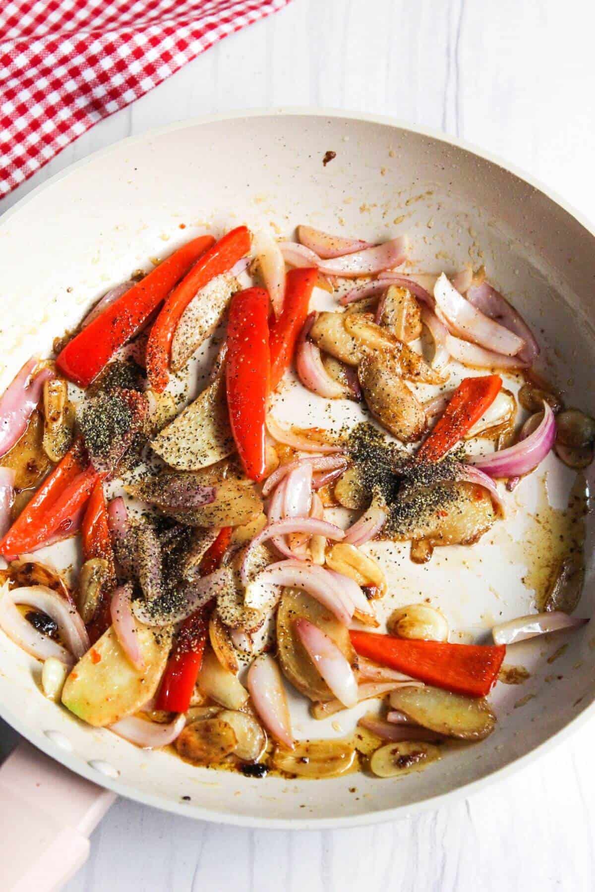 Cooked onion and pepper in skillet.