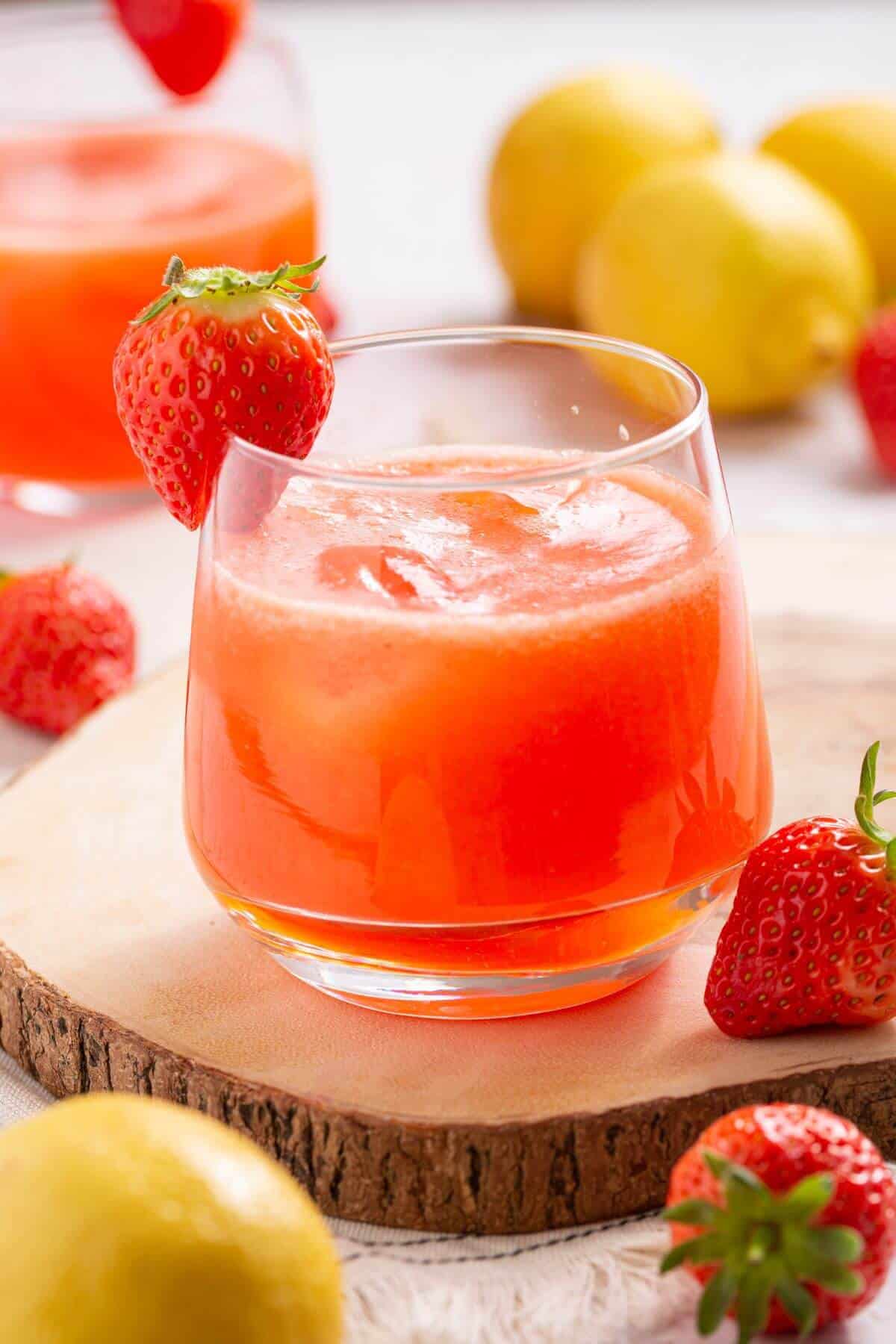 Strawberry lemonade in glasses with strawberries and lemons.