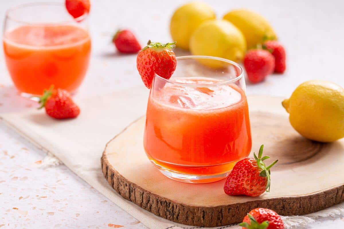 Strawberry lemonade in glasses with strawberries and lemons.