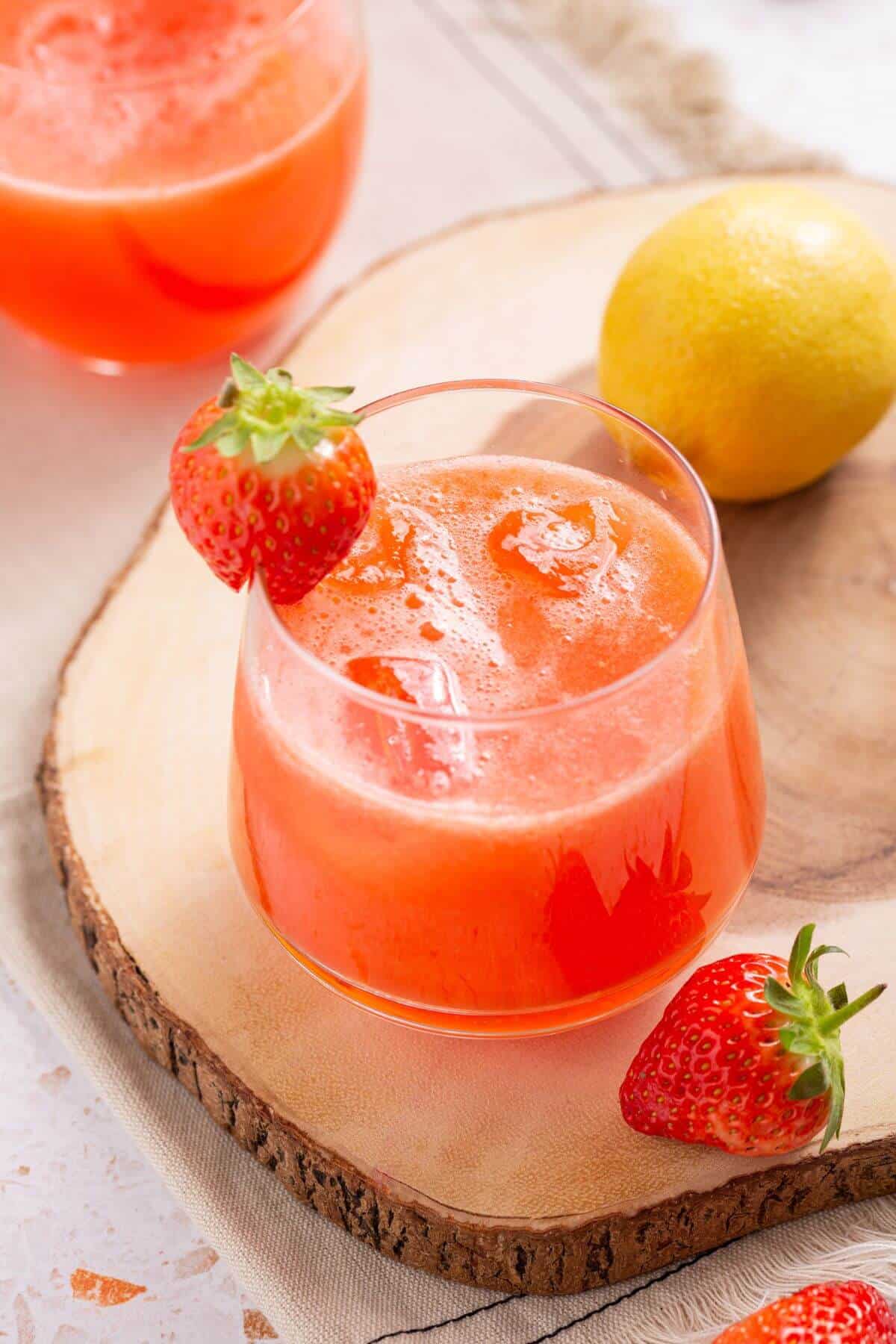 Angled shot over glass of strawberry lemonade.