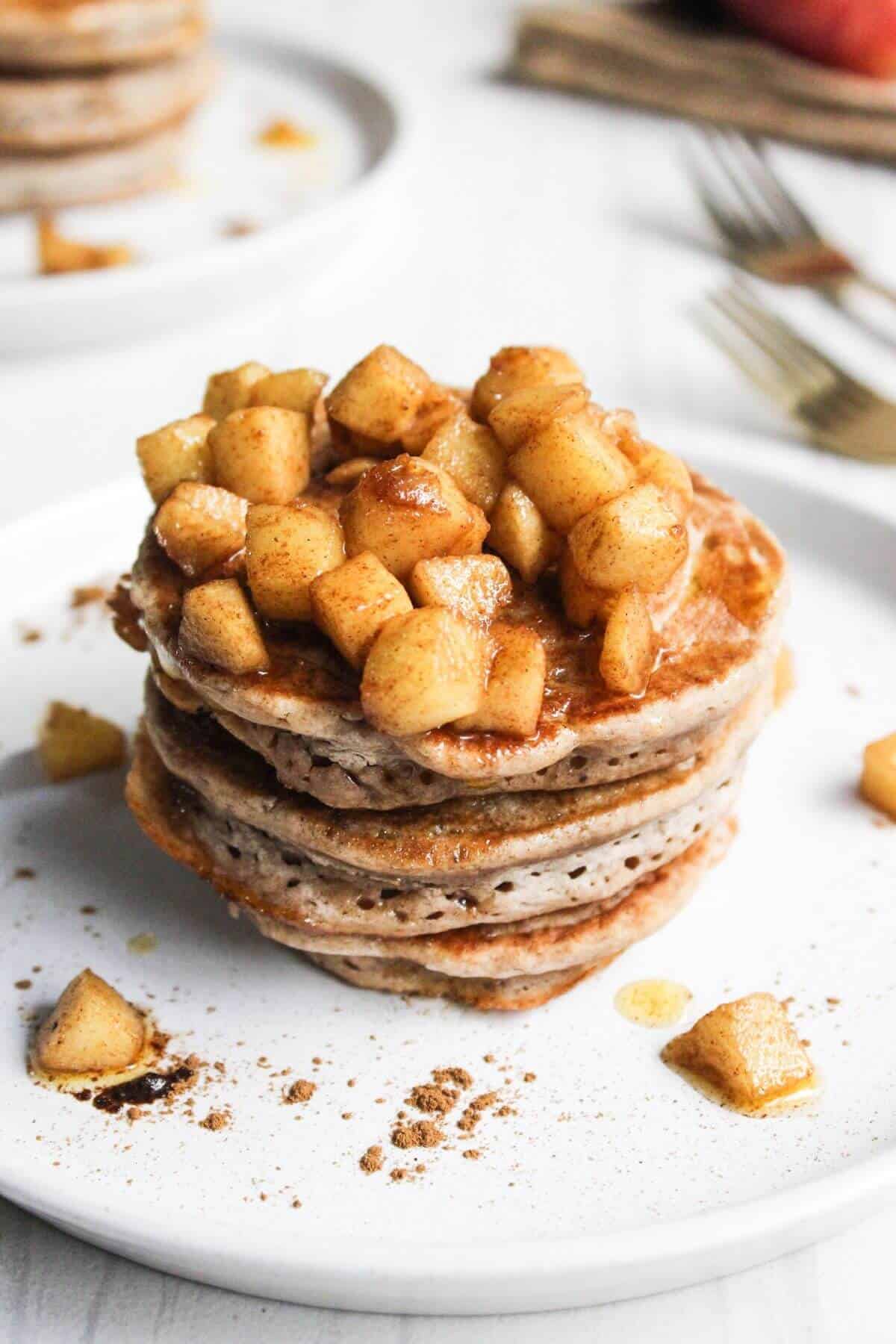 Stack of pancakes with apple topping.