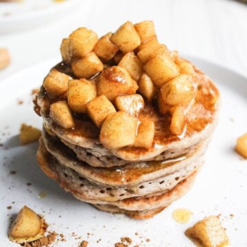Stack of pancakes with apple topping.