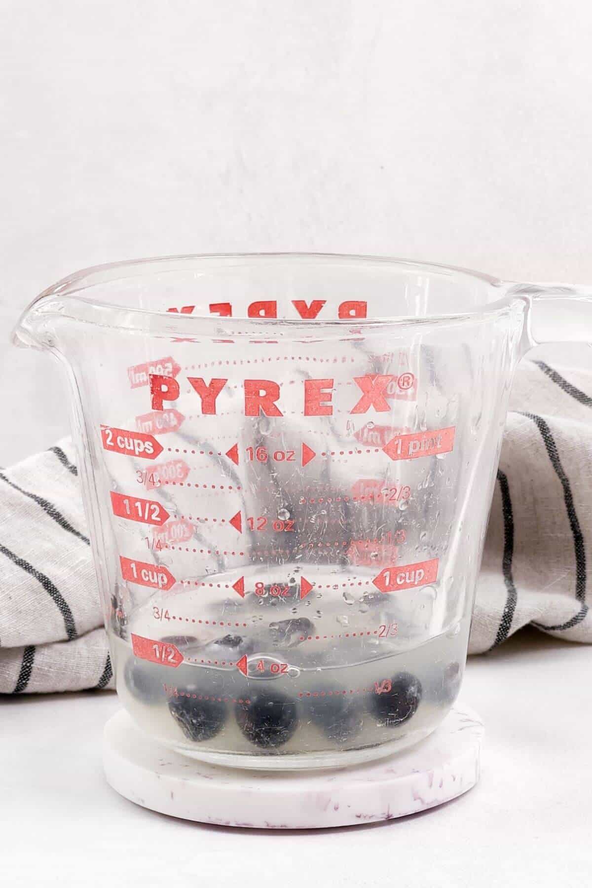 Blueberries added to Pyrex measuring cup.
