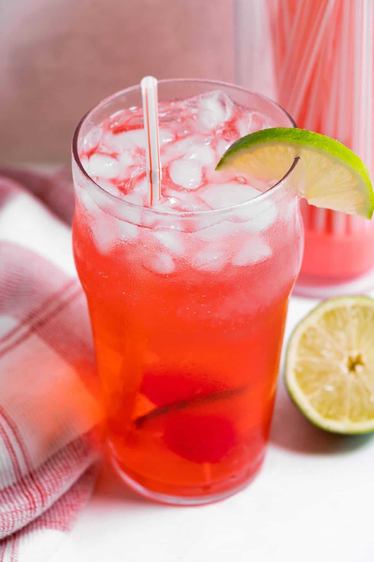 Top angled view of cherry limeade drink.