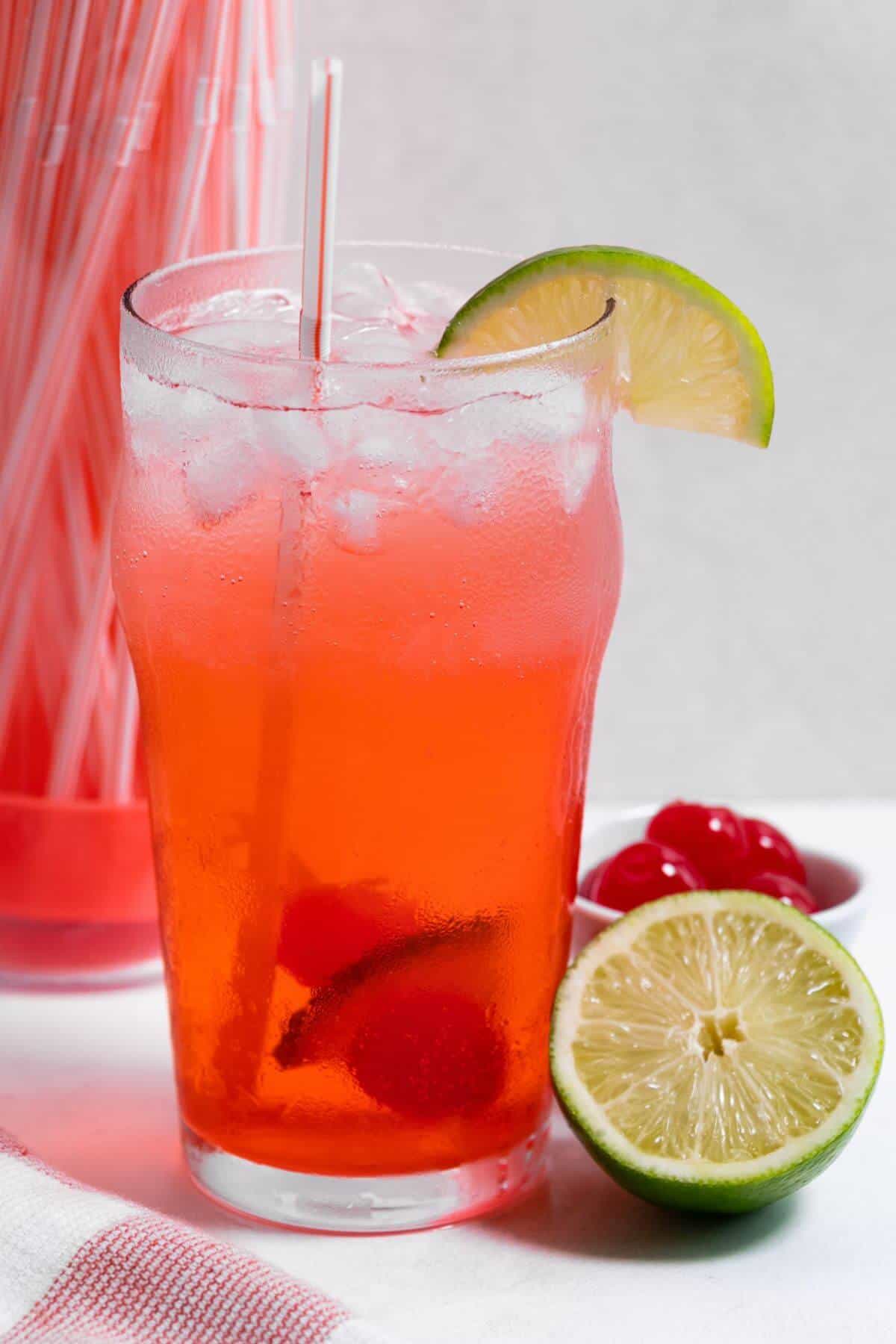 Side view of cherry limeade drink.