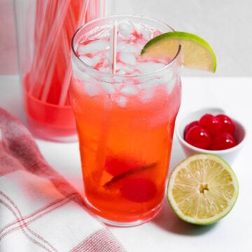 Top angled view of cherry limeade drink.