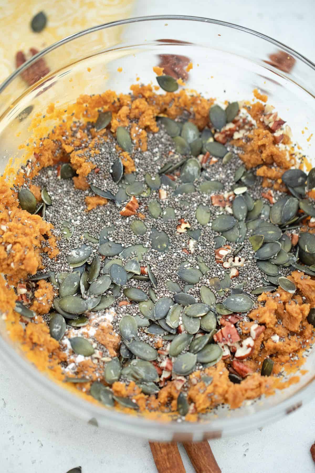 Pumpkin and chia seeds added to bowl.