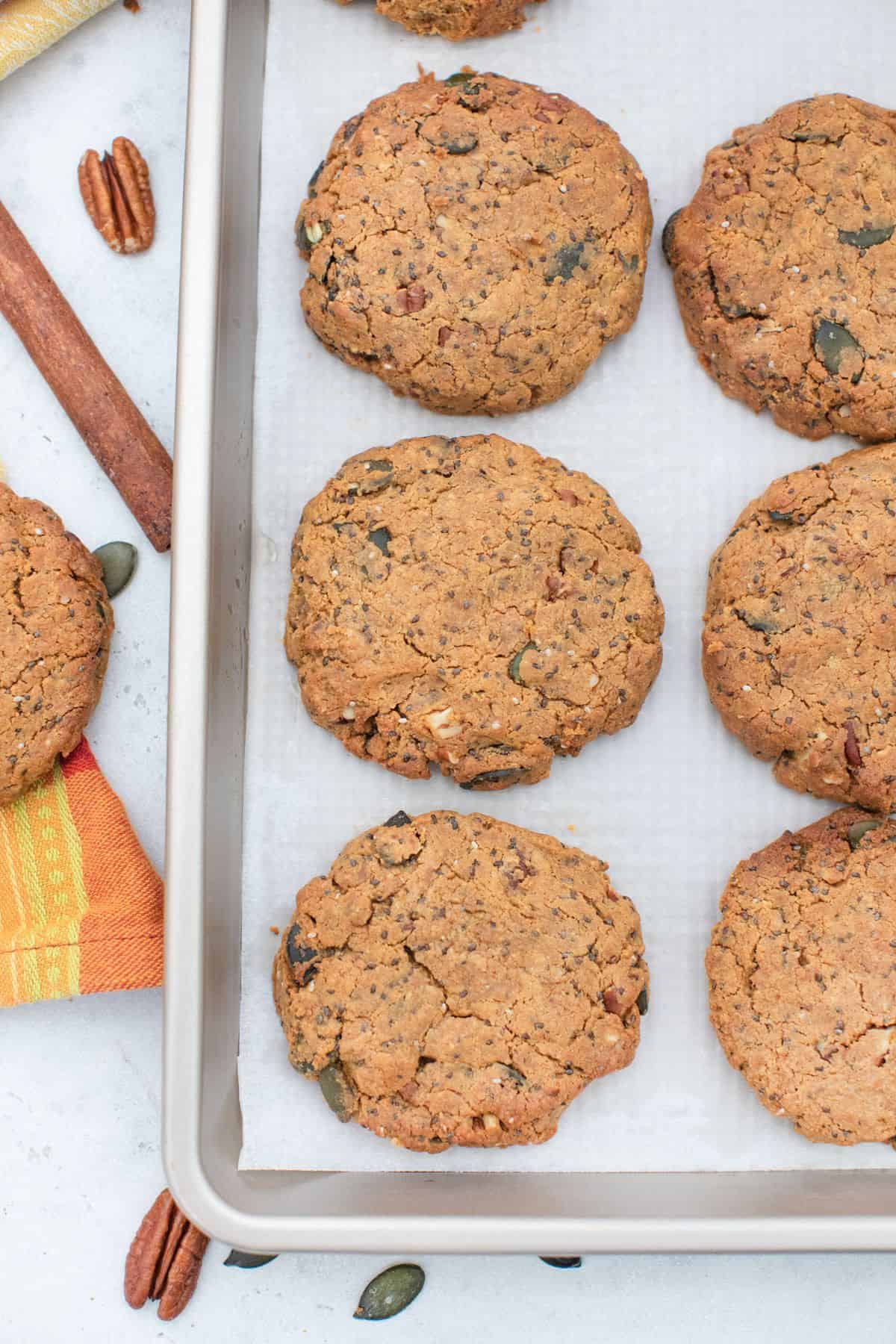 Baked breakfast cookies on parchment paper lined baking sheet.