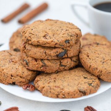 Healthy breakfast cookies on a plate with a cup of coffee.