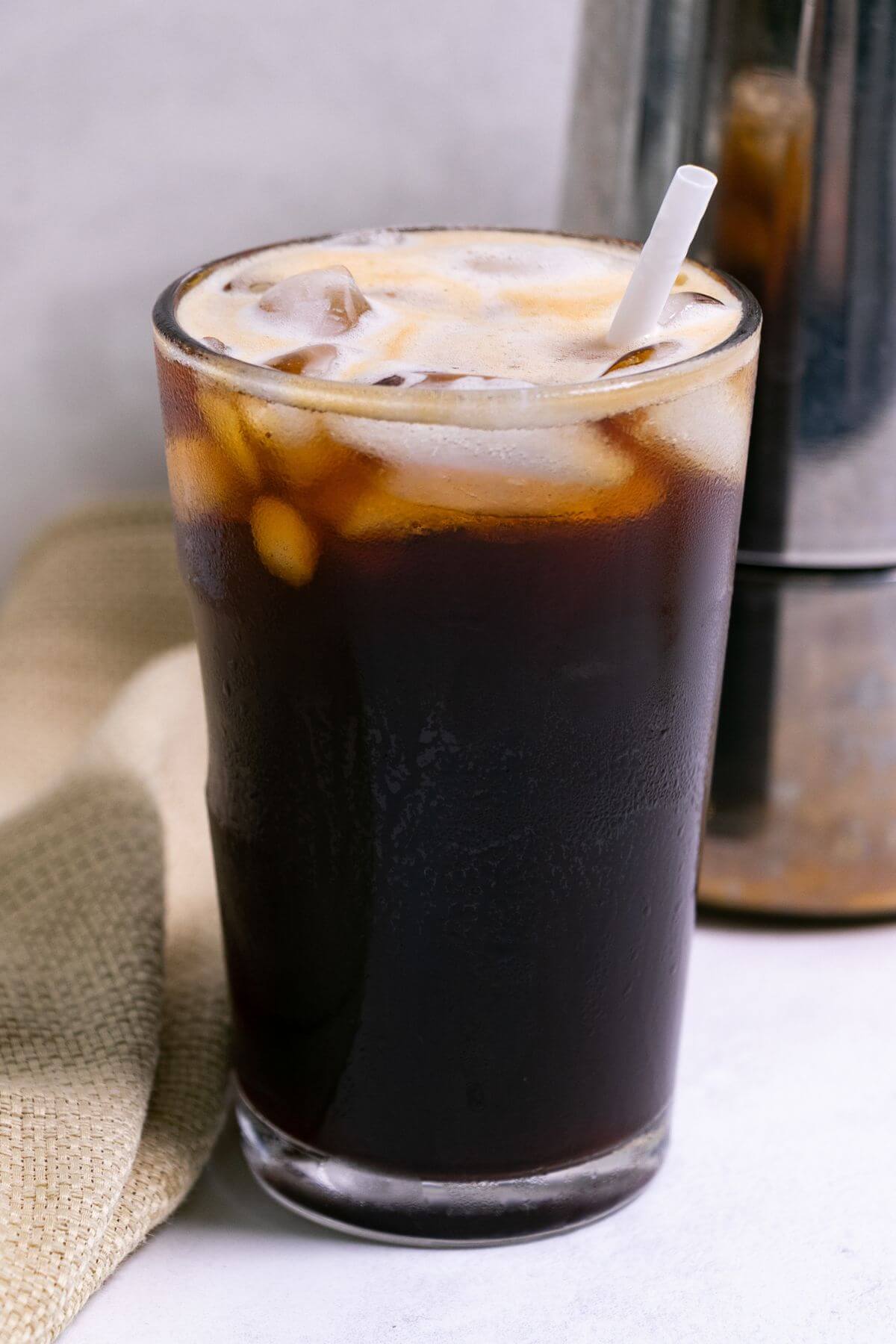Black iced Americano in tall glass. with moka pot.