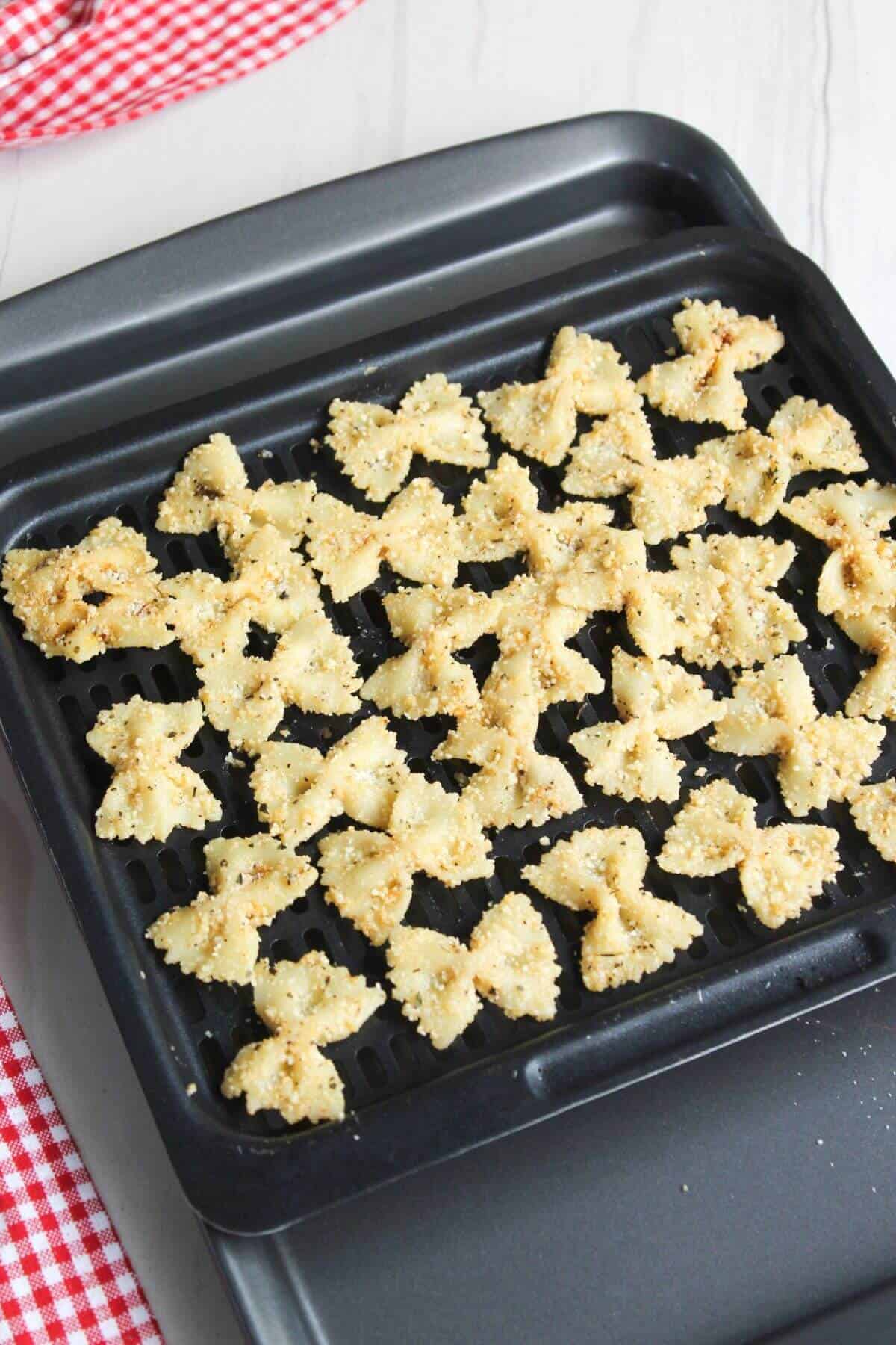 Prepared pasta on air fryer basket tray.