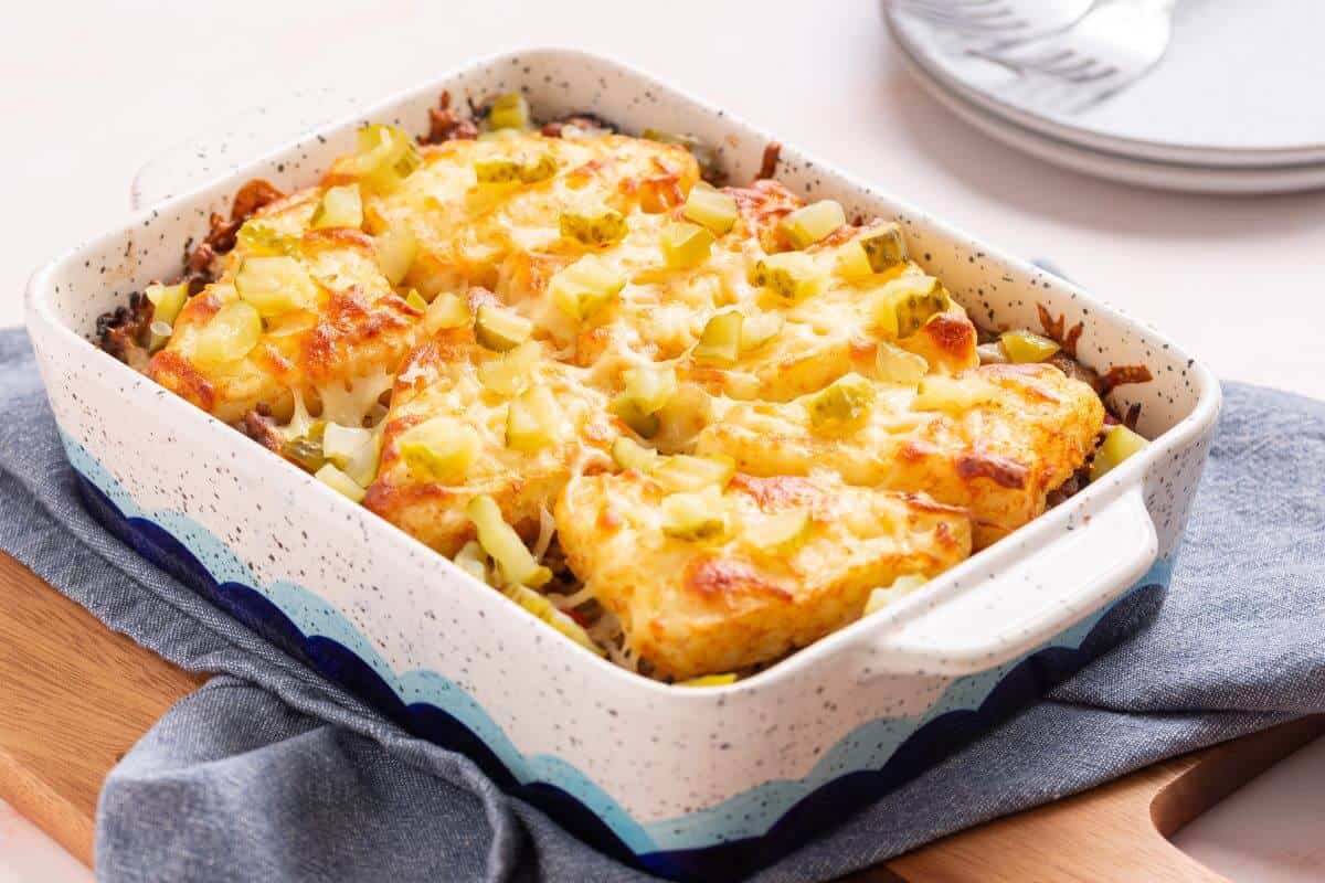 Cheesy hashbrown topped casserole in baking pan.