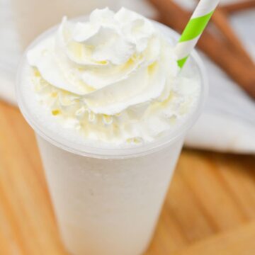 Vanilla bean frappuccino with green striped straw.