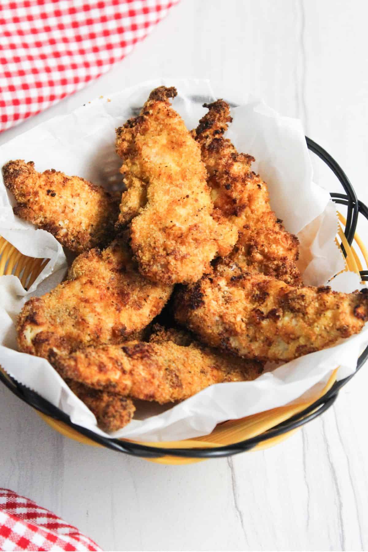 Air fried chicken tenders in a bowl on a table.