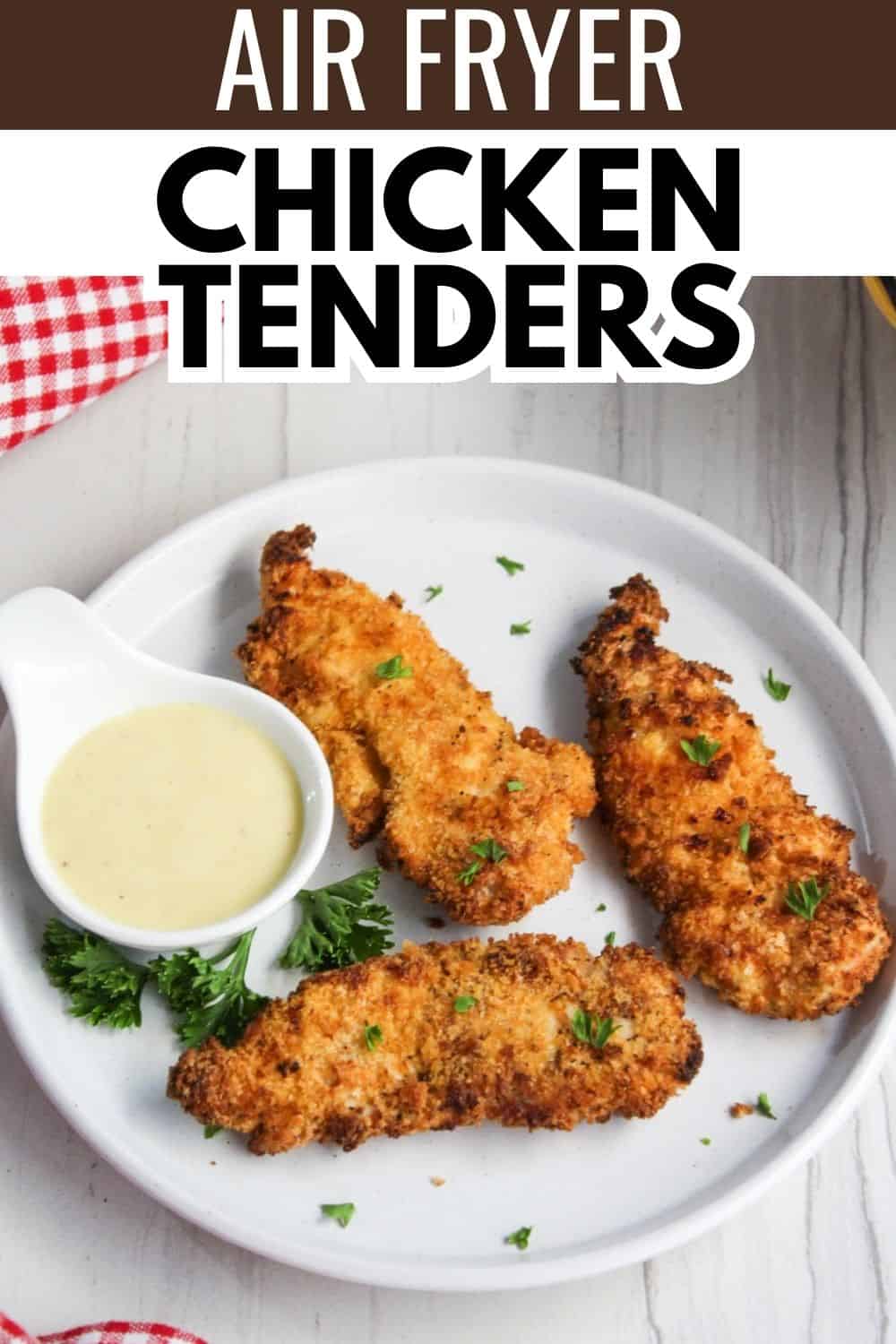 Air fryer chicken tenders on a plate with dipping sauce.