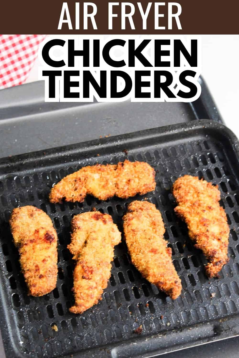 An air fryer with chicken tenders on it.